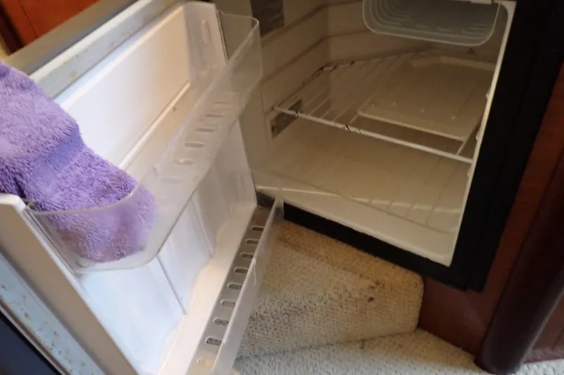 Slide: The Image of Open refrigerator inside a 2005 Sea Ray Sundancer 260 boat cabin. - 63
