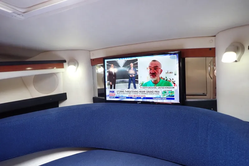 Slide: The Image of Interior of 2005 Sea Ray Sundancer 260 with TV and blue seating. - 68