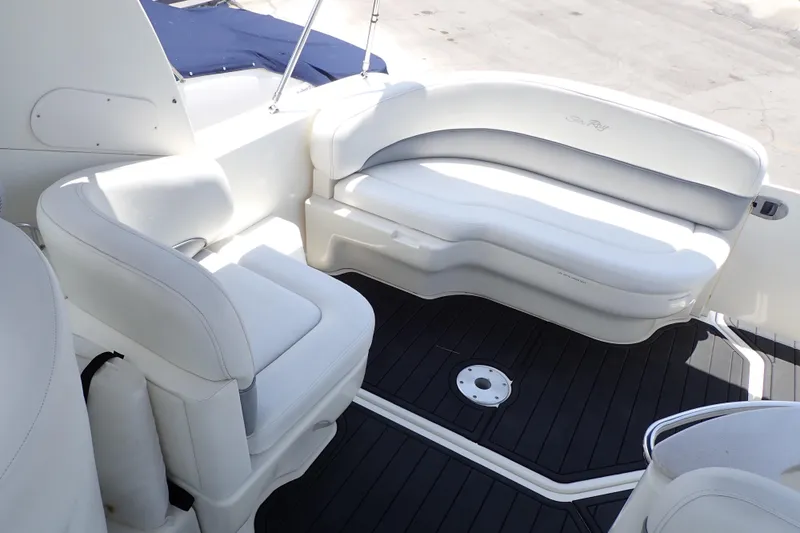 Slide: The Image of 2005 Sea Ray Sundancer 260 boat interior with white seating and dark flooring. - 7