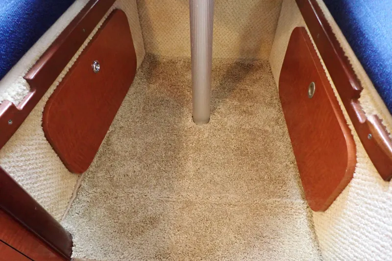 Slide: The Image of Interior cabin view of 2005 Sea Ray Sundancer 260 with carpet and wooden storage panels. - 73