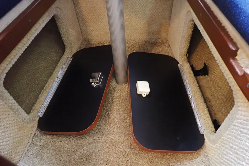 Slide: The Image of 2005 Sea Ray Sundancer 260 cabin interior with carpeted flooring and storage compartments. - 74