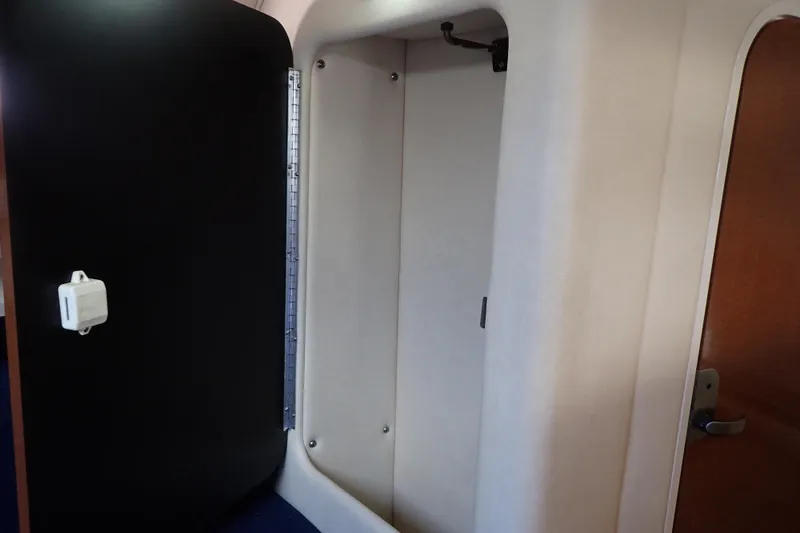 Slide: The Image of Interior cabin of 2005 Sea Ray Sundancer 260 boat, featuring a compact storage area. - 77