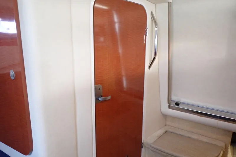 Slide: The Image of Interior of 2005 Sea Ray Sundancer 260, featuring wooden door and sleek design elements. - 79