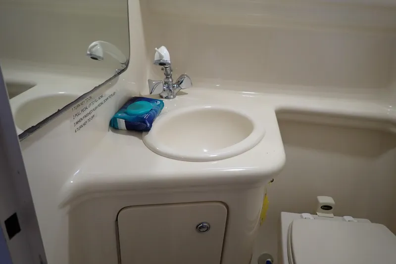 Slide: The Image of 2005 Sea Ray Sundancer 260 bathroom with sink, faucet, and toilet. - 80