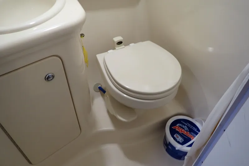 Slide: The Image of Compact bathroom in 2005 Sea Ray Sundancer 260 boat, featuring a toilet and sink. - 81