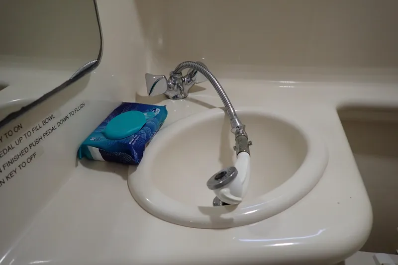 Slide: The Image of 2005 Sea Ray Sundancer 260 bathroom sink with faucet and cleaning wipes. - 82