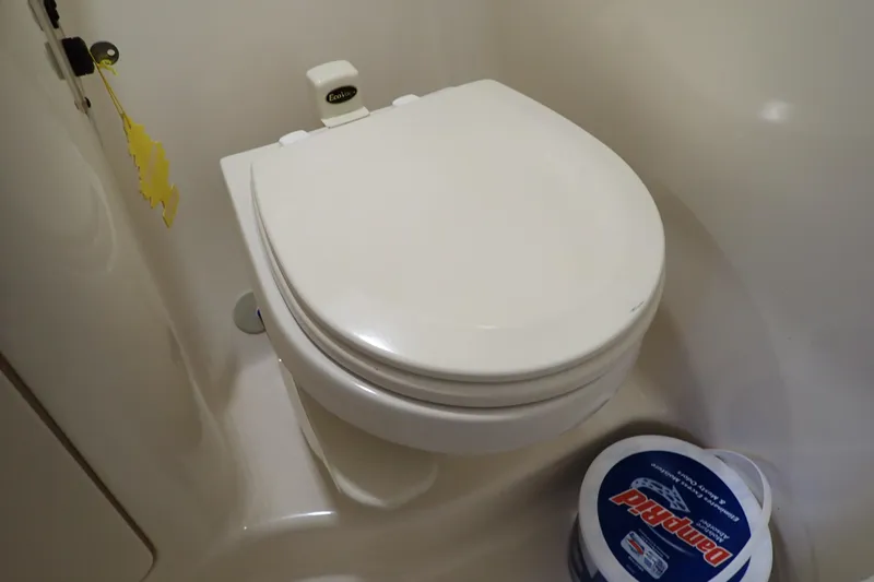 Slide: The Image of Boat bathroom with toilet and DampRid container, Sea Ray Sundancer 260, 2005 model. - 83
