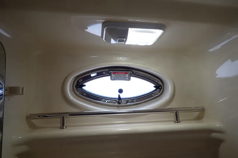 Slide: The Image of Interior view of 2005 Sea Ray Sundancer 260 boat with oval window and chrome rail. - 86
