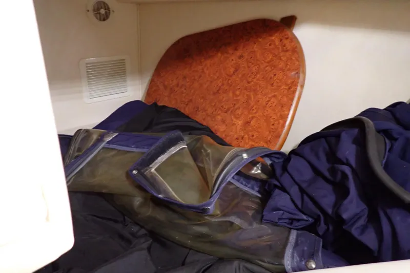 Slide: The Image of Interior storage area of a 2005 Sea Ray Sundancer 260 boat with folded items. - 89