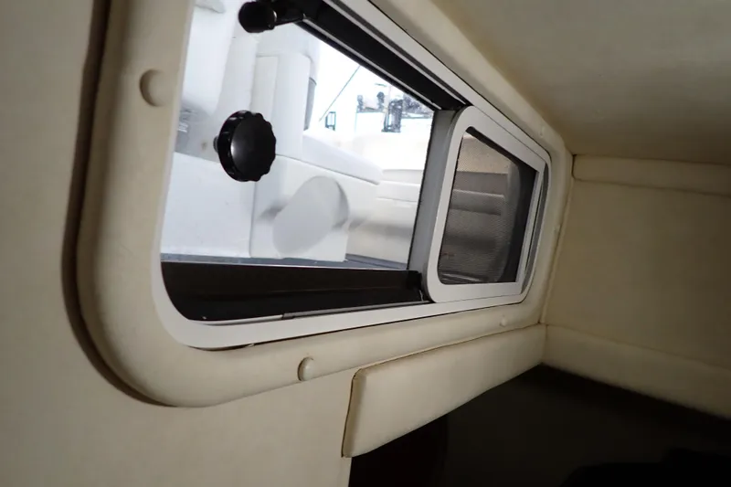 Slide: The Image of Interior cabin view of a 2005 Sea Ray Sundancer 260 boat with a window. - 90
