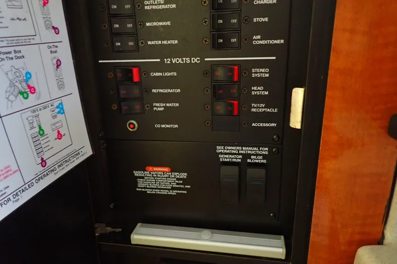 Slide: The Image of Control panel of a 2005 Sea Ray Sundancer 260 boat, featuring various switches and instructions. - 93