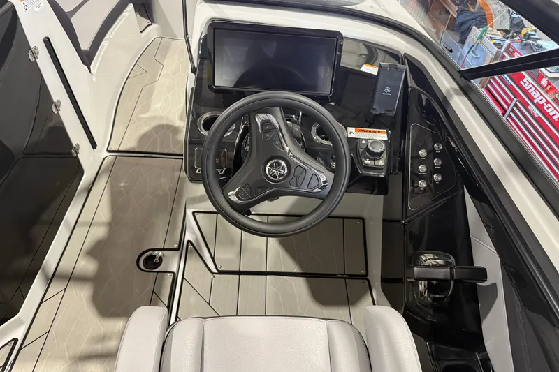 Slide: The Image of 2025 Yamaha Boats 255XD cockpit with modern steering wheel and control panel. - 11
