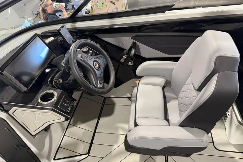 Slide: The Image of 2025 Yamaha Boats 255XD cockpit with modern steering, touchscreen, and comfortable seating. - 13