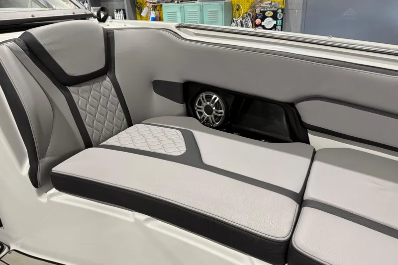 Slide: The Image of 2025 Yamaha Boats 255XD interior seating with stylish gray upholstery and speaker system. - 15