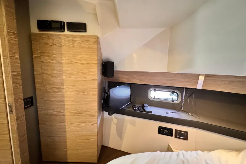 Slide: The Image of Interior cabin of 2020 Azimut Verve 40 yacht with modern wood paneling and small window. - 30