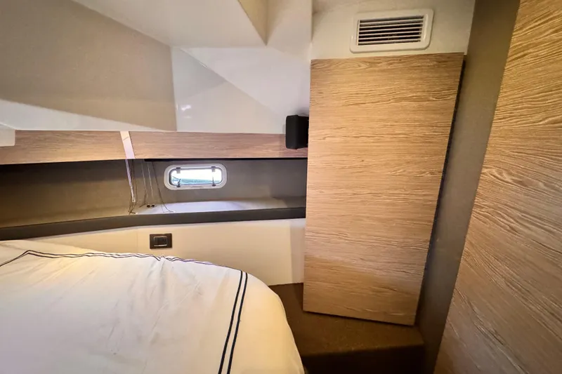Slide: The Image of Interior cabin of 2020 Azimut Verve 40 yacht, featuring modern wood paneling and a small window. - 31