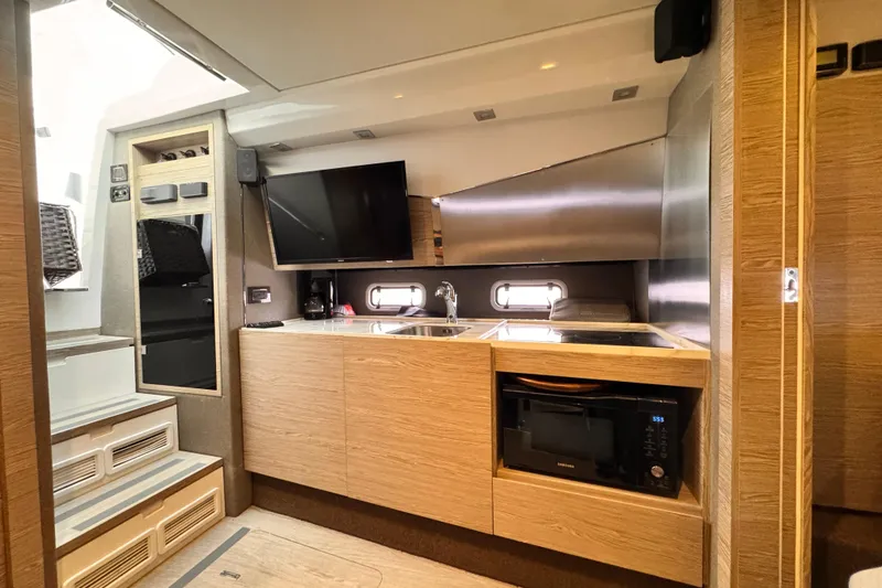 Slide: The Image of Modern kitchen interior of 2020 Azimut Verve 40 yacht with wood cabinetry and appliances. - 36
