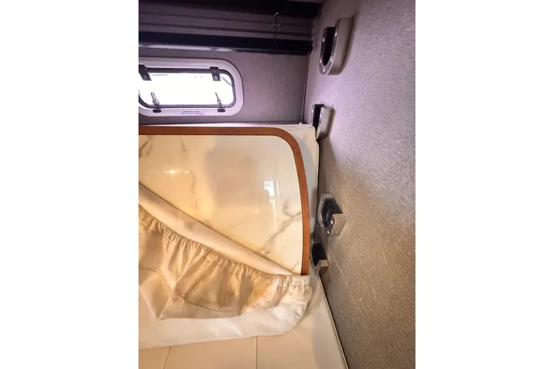 Slide: The Image of Interior cabin view of 2020 Azimut Verve 40 yacht, featuring a window and bedding. - 38