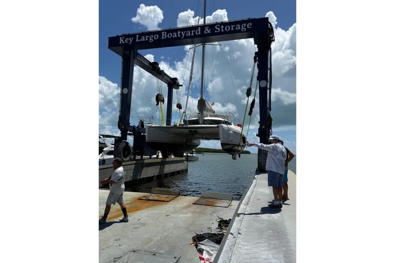 Slide: The Image of A 1995 Fountaine Pajot Athena 38 catamaran being lifted at Key Largo Boatyard. - 10