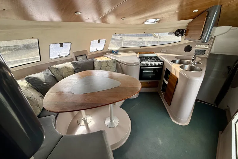Slide: The Image of Interior of 1995 Fountaine Pajot Athena 38 catamaran with cozy seating and compact kitchen. - 15