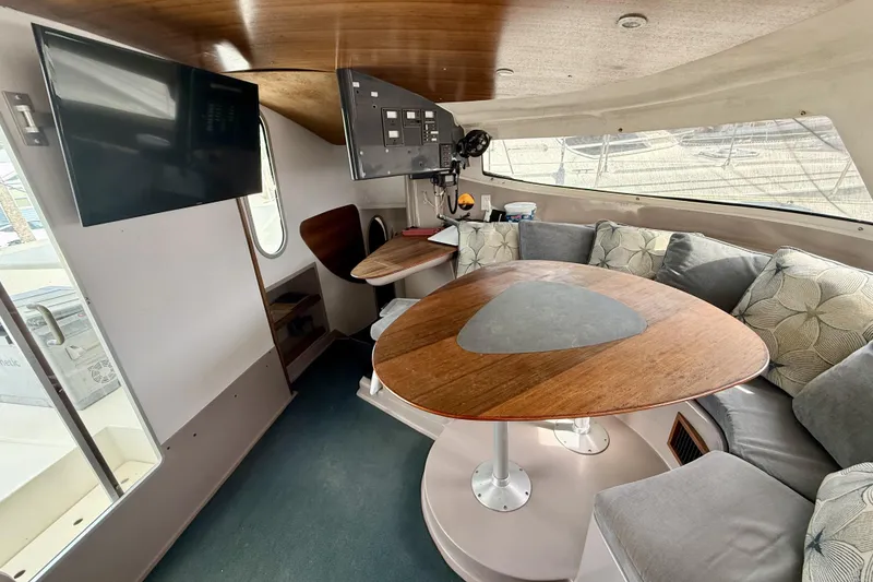 Slide: The Image of Interior of 1995 Fountaine Pajot Athena 38 catamaran with cozy seating and wooden table. - 18