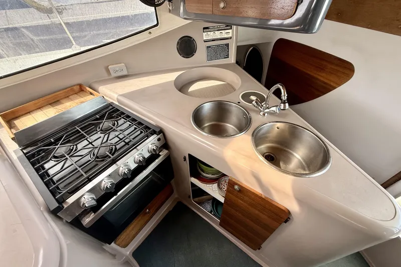 Slide: The Image of Compact kitchen in 1995 Fountaine Pajot Athena 38 catamaran with stove and dual sinks. - 19