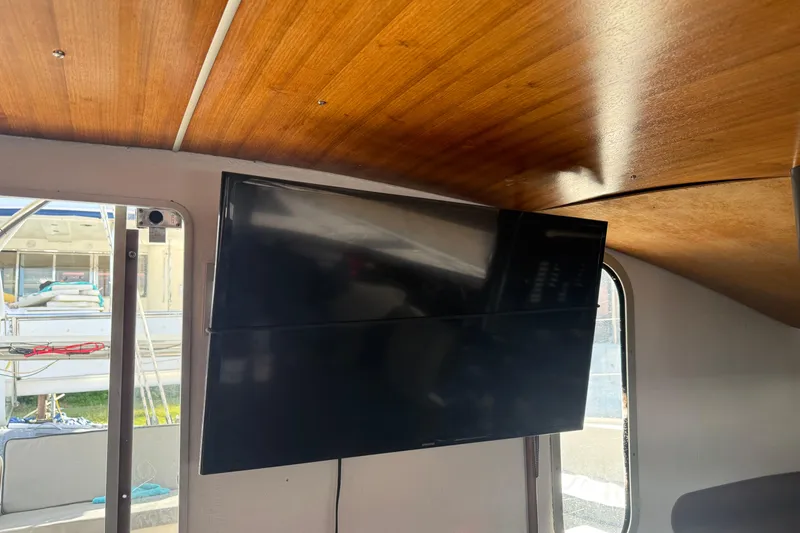 Slide: The Image of Interior of 1995 Fountaine Pajot Athena 38 with mounted flat-screen TV and wooden ceiling. - 22
