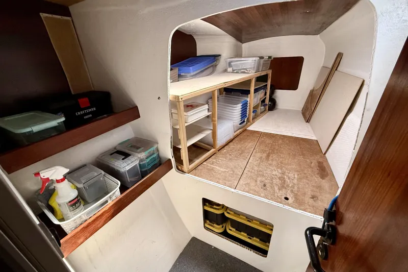Slide: The Image of Storage area inside a 1995 Fountaine Pajot Athena 38 catamaran, featuring shelves and organized containers. - 29