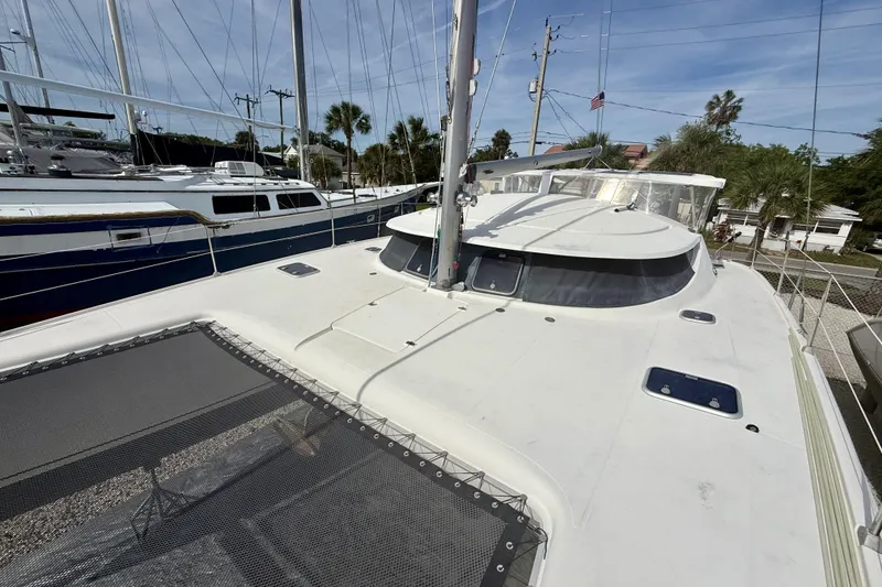 Slide: The Image of 1995 Fountaine Pajot Athena 38 catamaran docked, showcasing deck and rigging details. - 3