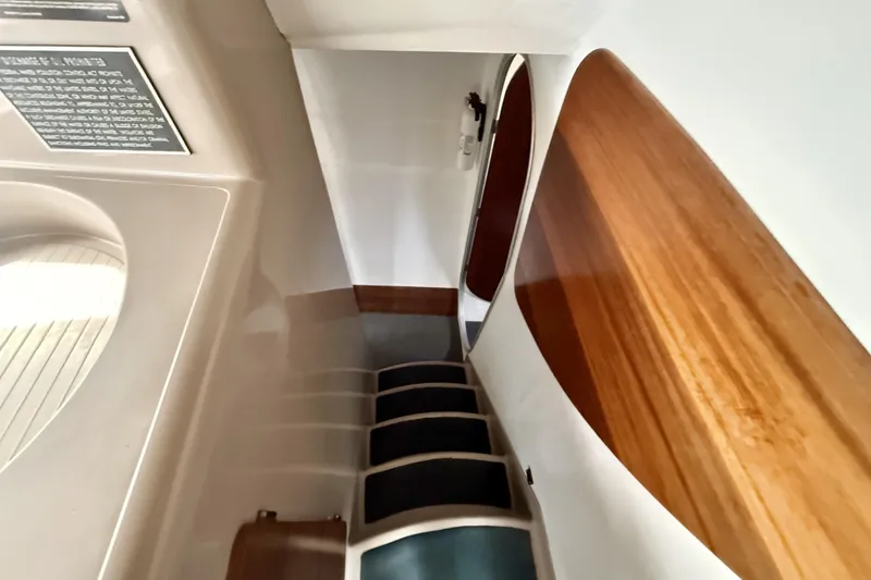 Slide: The Image of Interior view of 1995 Fountaine Pajot Athena 38 yacht, featuring sleek wooden finishes and stairs. - 32