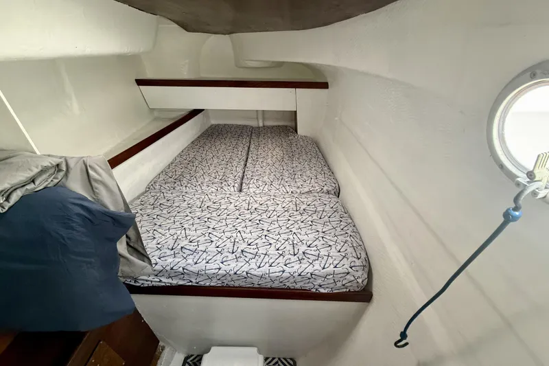 Slide: The Image of Cozy cabin interior of 1995 Fountaine Pajot Athena 38 catamaran with patterned bedding. - 33