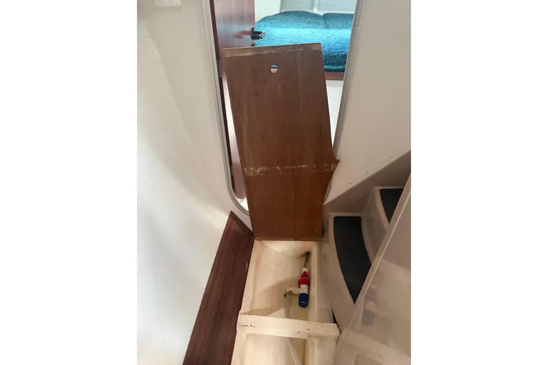 Slide: The Image of Interior view of a 1995 Fountaine Pajot Athena 38 sailboat, showing a wooden panel and stairs. - 35