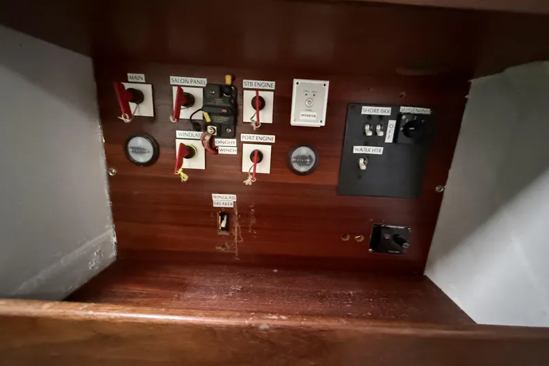 Slide: The Image of Control panel of a 1995 Fountaine Pajot Athena 38 catamaran with labeled switches and gauges. - 44