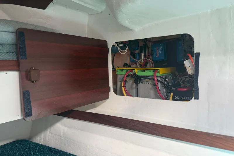 Slide: The Image of Electrical compartment of a 1995 Fountaine Pajot Athena 38 catamaran, showcasing wiring and components. - 45