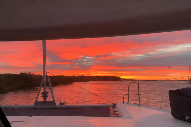 Slide: The Image of Sunset view from 1995 Fountaine Pajot Athena 38 catamaran on tranquil waters. - 8