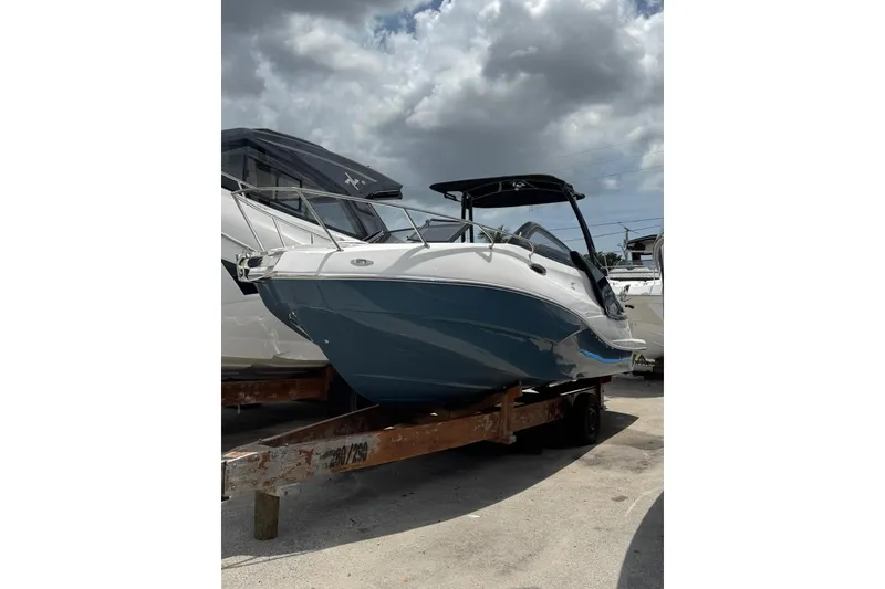 The Image of 2025 NX Boats NX270 on trailer under cloudy sky, showcasing sleek design. - 1