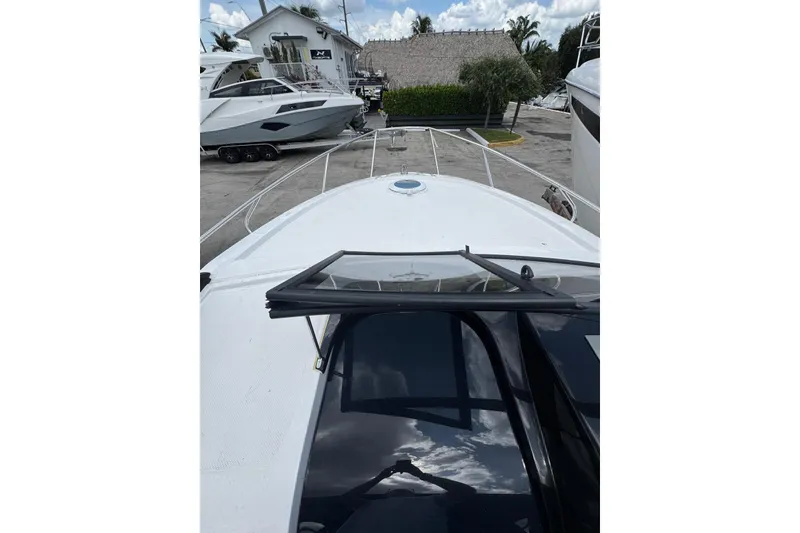 Slide: The Image of 2025 NX Boats NX270 yacht, docked with open hatch, showcasing sleek design and modern features. - 15