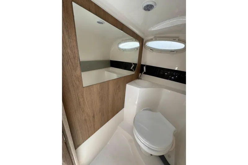 Slide: The Image of Modern bathroom interior of 2025 NX Boats NX270, featuring sleek design and wood accents. - 17