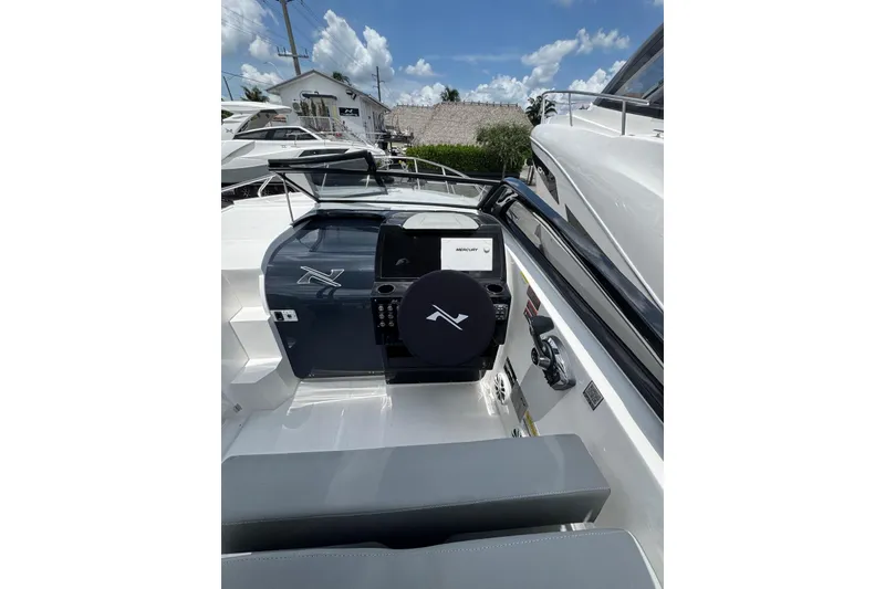 Slide: The Image of 2025 NX Boats NX270 cockpit with modern controls, sleek design, and comfortable seating. - 6