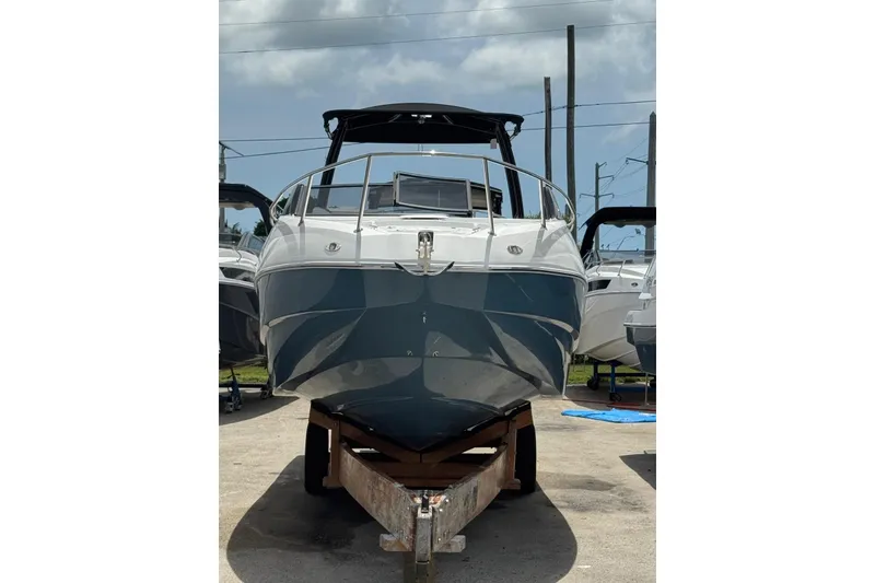 Slide: The Image of 2025 NX Boats NX270 on trailer, front view under sunny sky. - 7