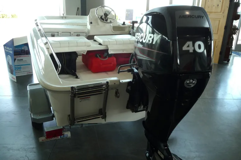 Slide: The Image of 2016 Boston Whaler 130 Super Sport with Mercury 40 outboard motor in showroom. - 11
