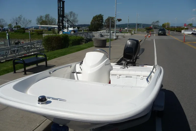 Slide: The Image of 2016 Boston Whaler 130 Super Sport boat parked near a waterfront area. - 3