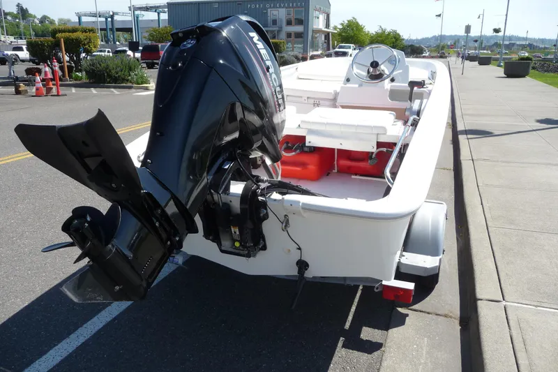 Slide: The Image of 2016 Boston Whaler 130 Super Sport boat with Mercury engine, parked on a street. - 5