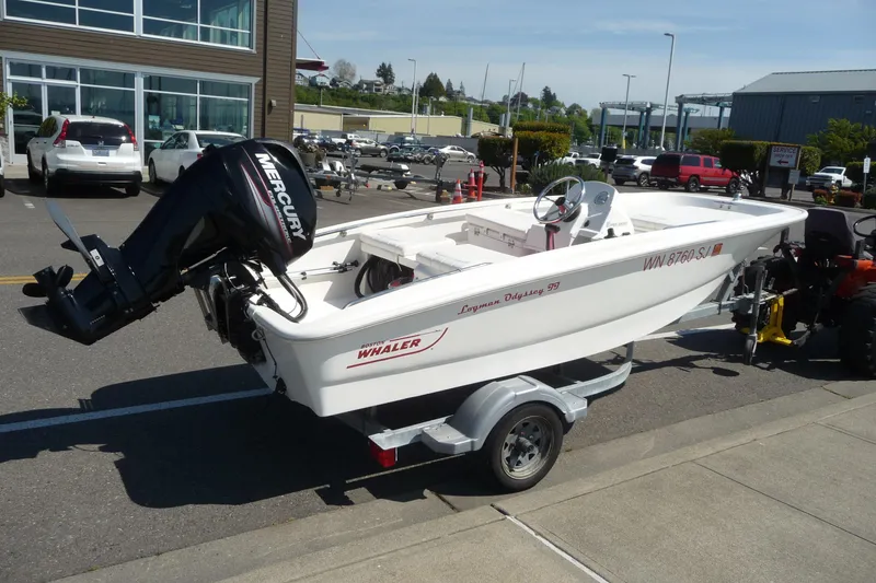 Slide: The Image of 2016 Boston Whaler 130 Super Sport boat on trailer, parked outdoors. - 6