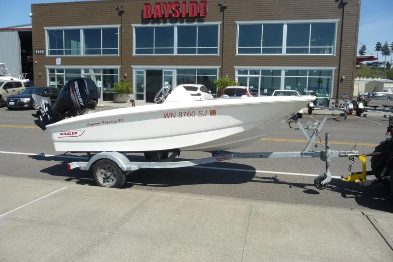 Slide: The Image of 2016 Boston Whaler 130 Super Sport boat on trailer outside Bayside building. - 8