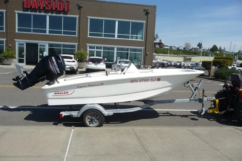 Slide: The Image of 2016 Boston Whaler 130 Super Sport boat on trailer outside Bayside building. - 9