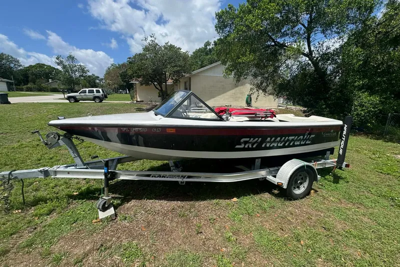 Slide: The Image of 1992 Nautique Ski Nautique 200 Closed Bow boat on trailer, parked on grass. - 6