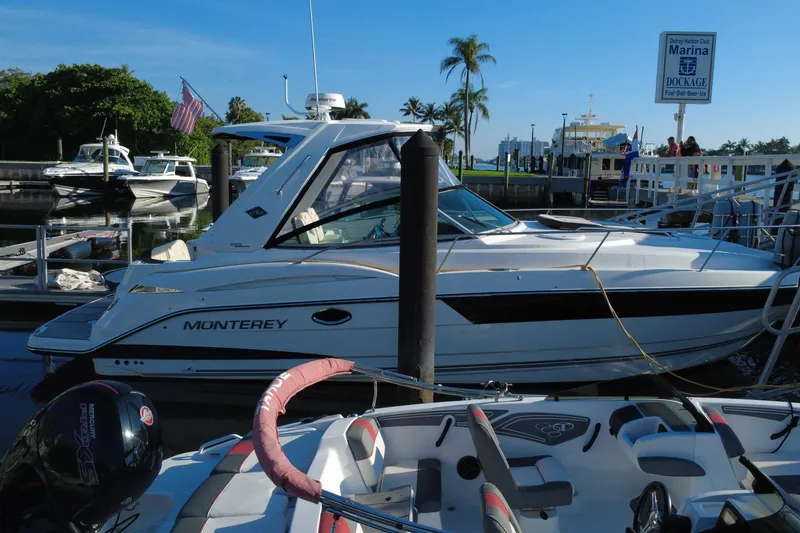 Slide: The Image of 2018 Monterey 355 Sport Yacht docked at marina with palm trees in background. - 4