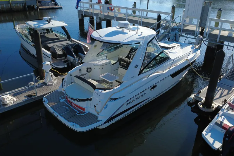 Slide: The Image of 2018 Monterey 355 Sport Yacht docked at marina, rear view. - 7