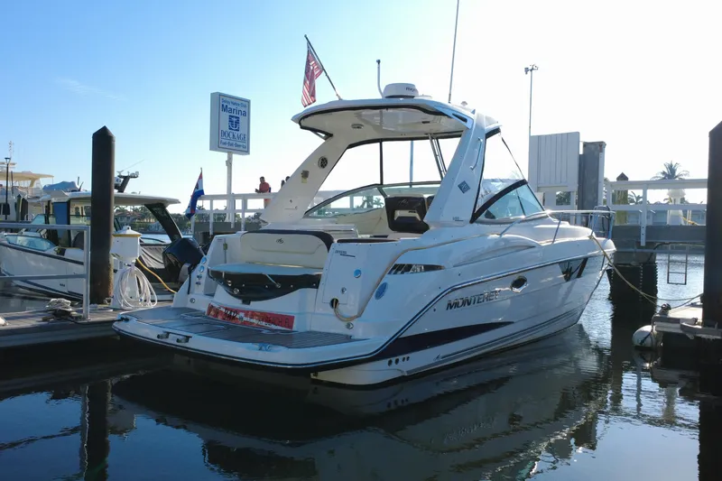 Slide: The Image of 2018 Monterey 355 Sport Yacht docked at marina under clear blue sky. - 8